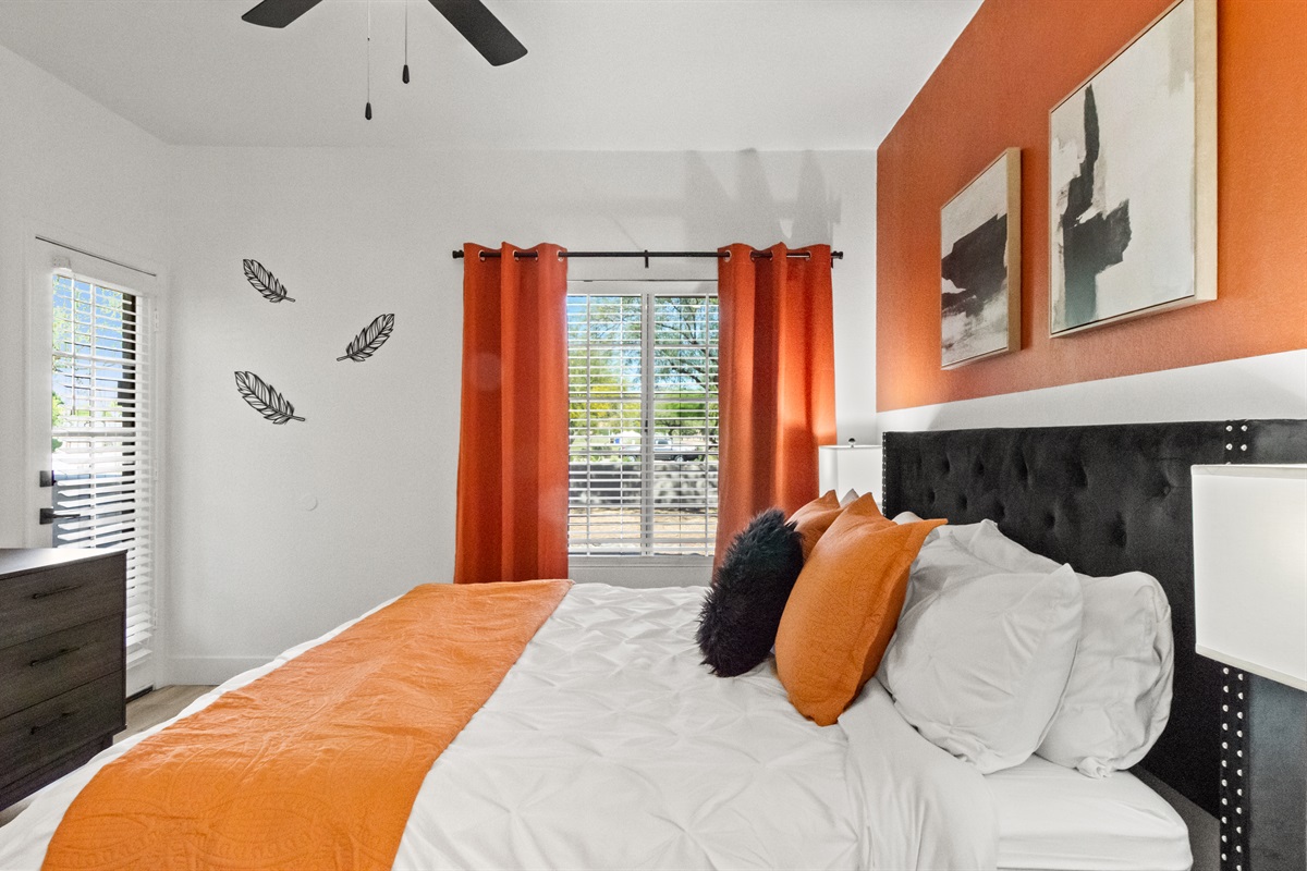 This inviting bedroom features a premium bed with fresh linens and extra pillows, creating the perfect space for restful sleep and relaxation.