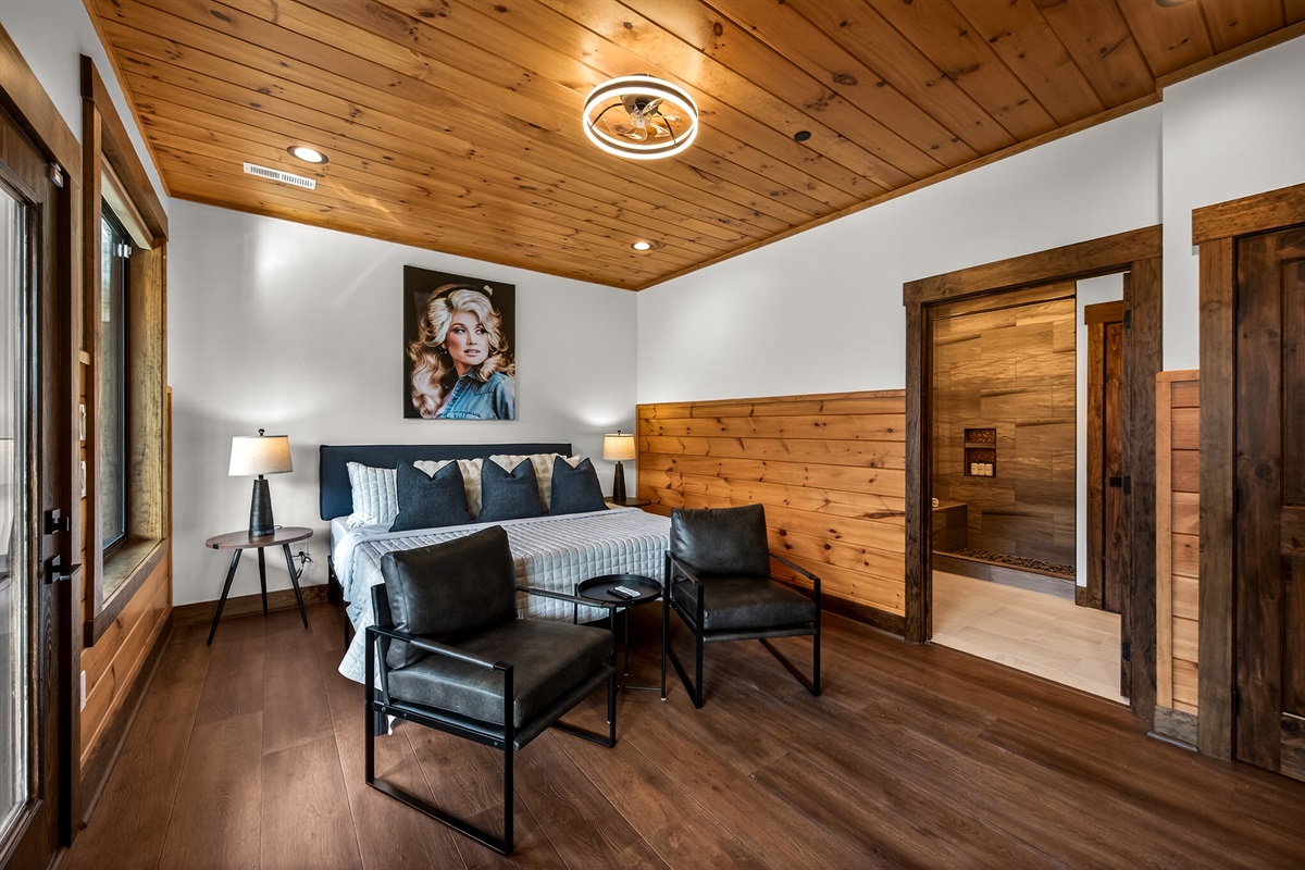 Relax in the spacious king bedroom on the game room level with a big TV, desk & direct deck hot tub access. Unwind in the en-suite bathroom featuring a walk-in shower with a natural river rock floor, bringing  the Smoky Mountains indoors for a spa retreat.