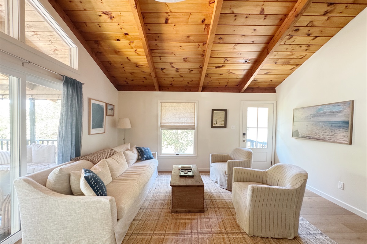 Spacious living room with FrameTV, open to the kitchen, with vaulted tongue and groove ceilings.