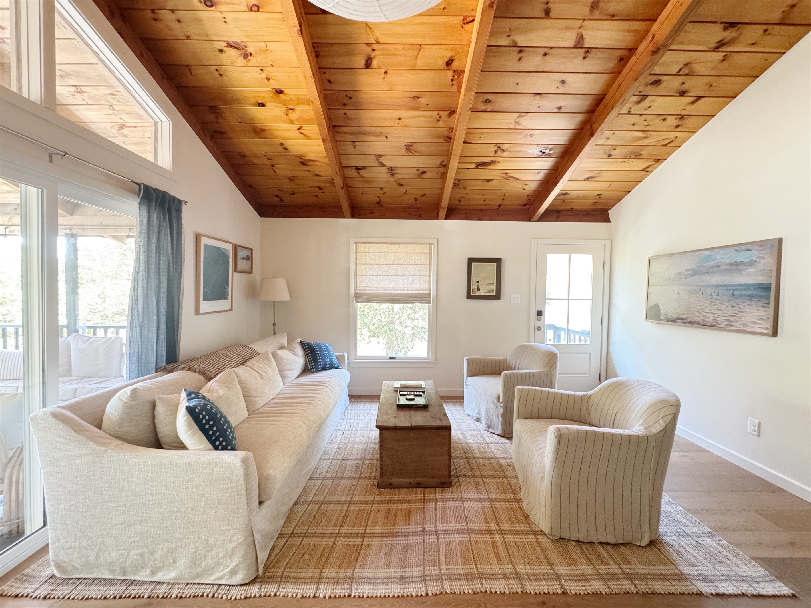 Spacious living room with FrameTV, open to the kitchen, with vaulted tongue and groove ceilings.