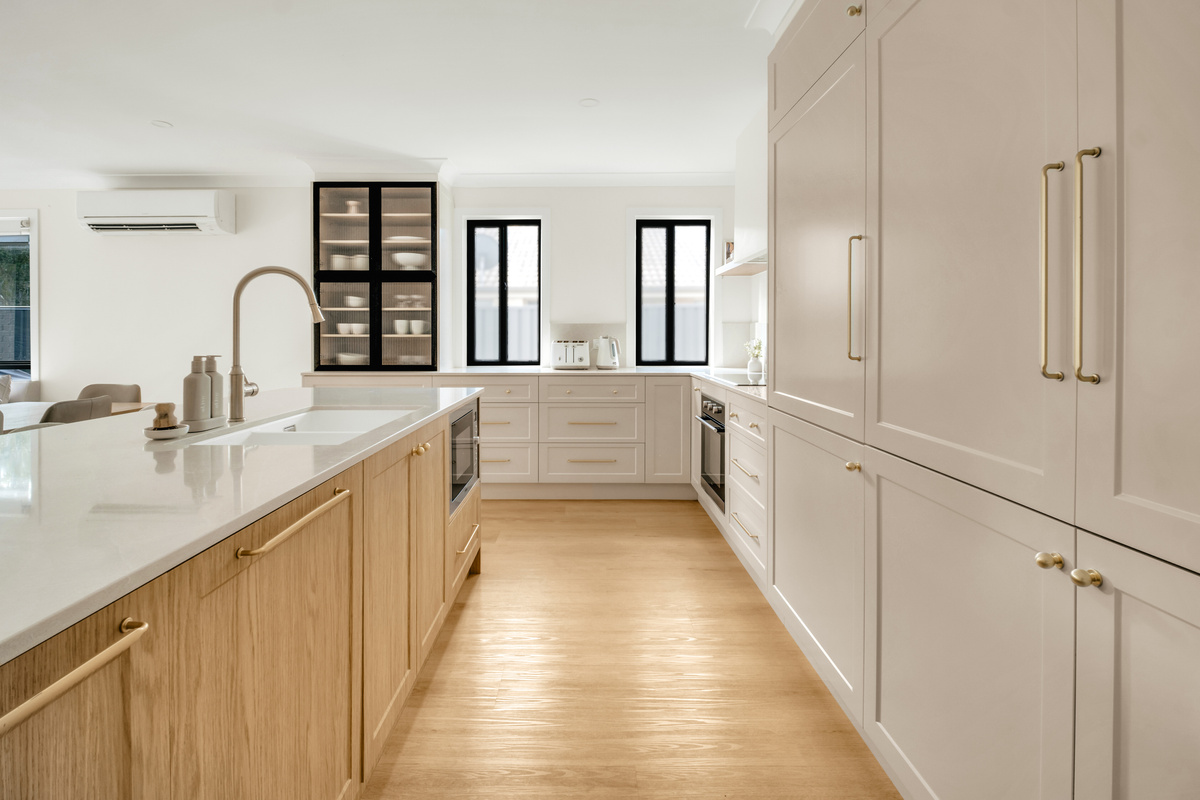 Wide kitchen drawers add useful storage beside the island, helping keep cookware and everyday items within easy reach.