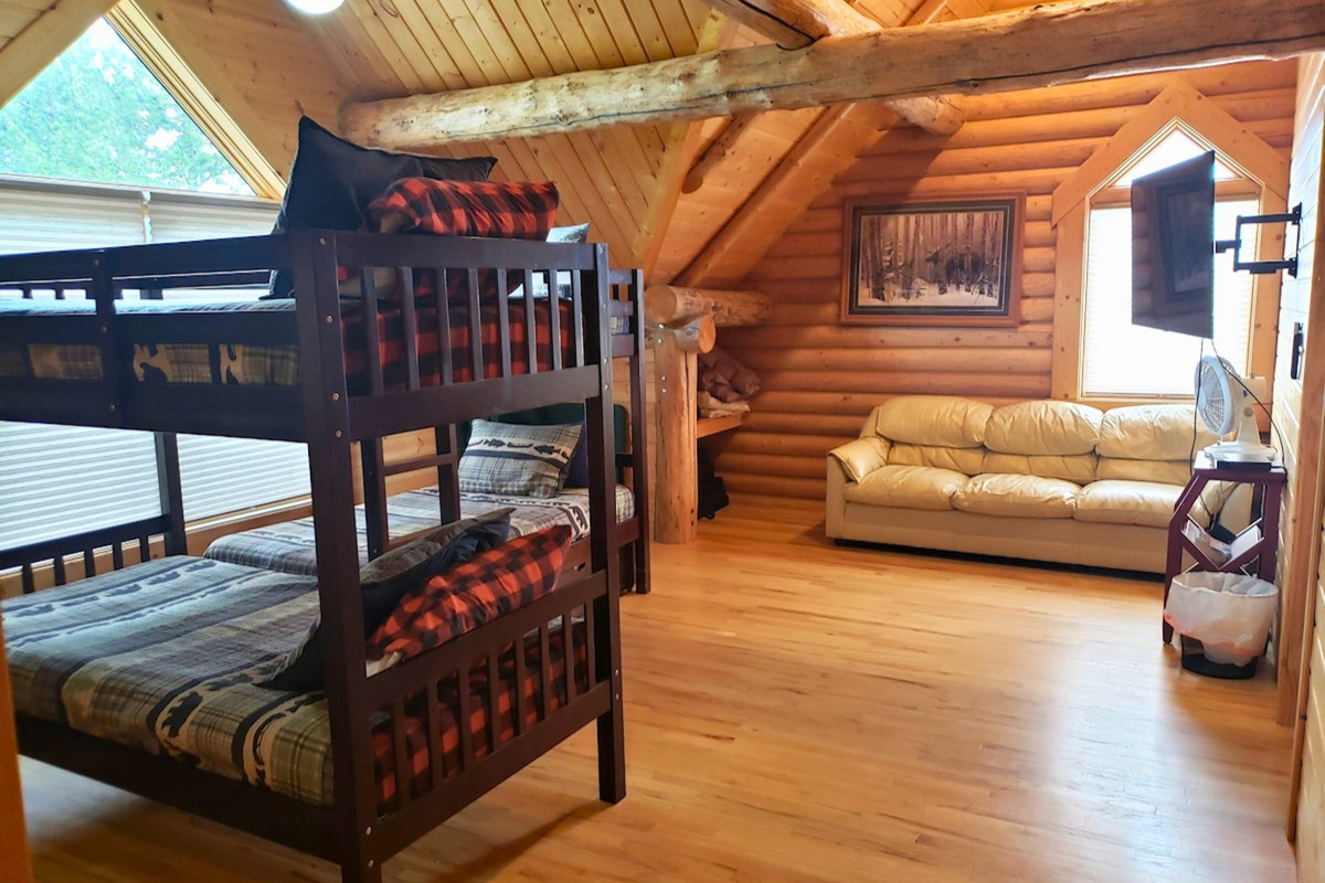 A TV and couch make the bunk room perfect for kids to hang out in.