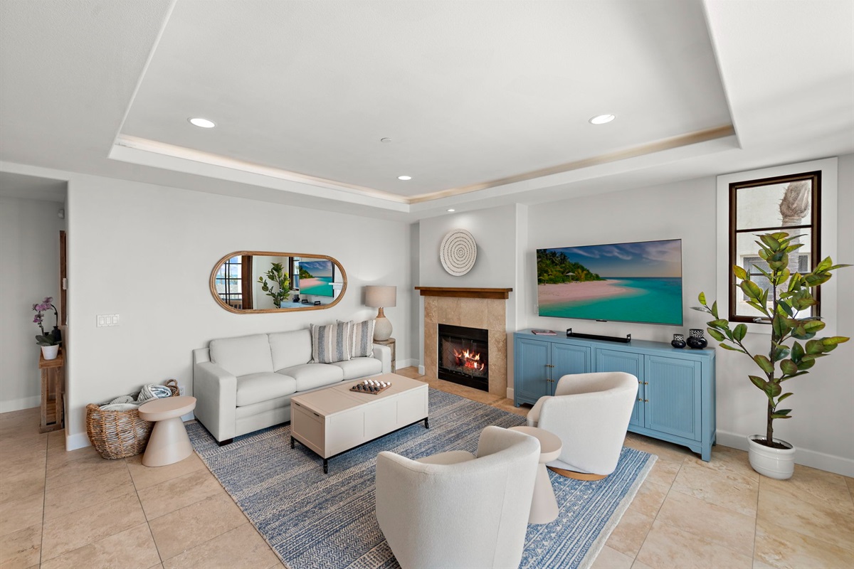 Enjoy the cozy fireplace while you watch your favorite shows on a 65" smart TV (over blue cradenza).  We offer Amazon Prime, Sling TV, Peacock, Hulu, Disney, Max and Paramount plus as well as over 300 movies in our amazon library.