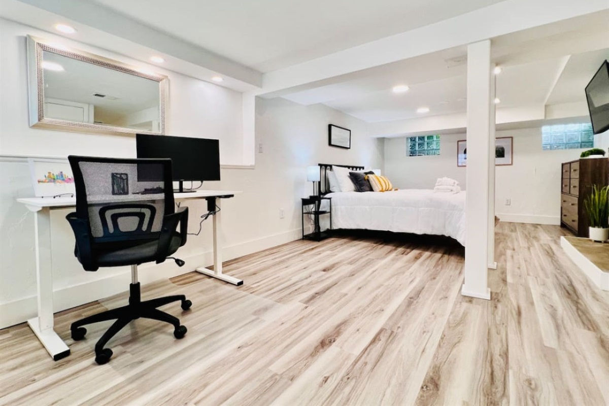 Spacious queen-sized bedroom with a dedicated working space and a TV, offering the perfect blend of comfort, productivity, and entertainment.