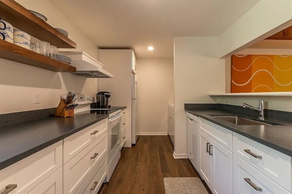 Modern kitchen: Sleek countertops, open-shelving, and all the tools needed for your culinary adventures.