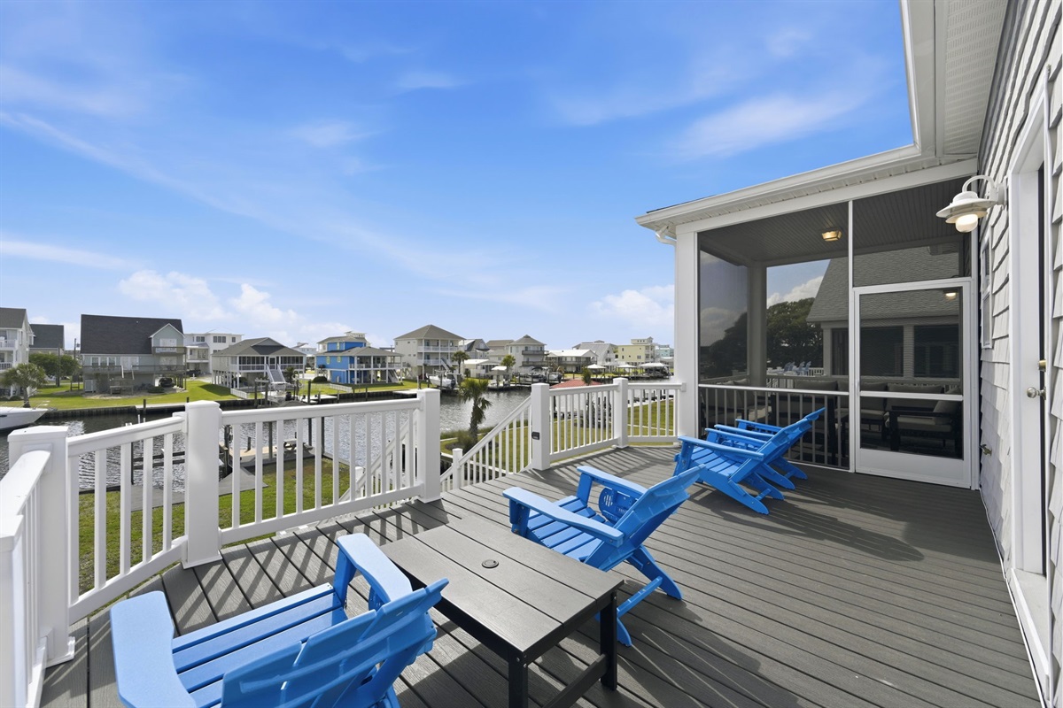 Enjoy outdoor living with waterfront views and cozy seating just steps from the master suite