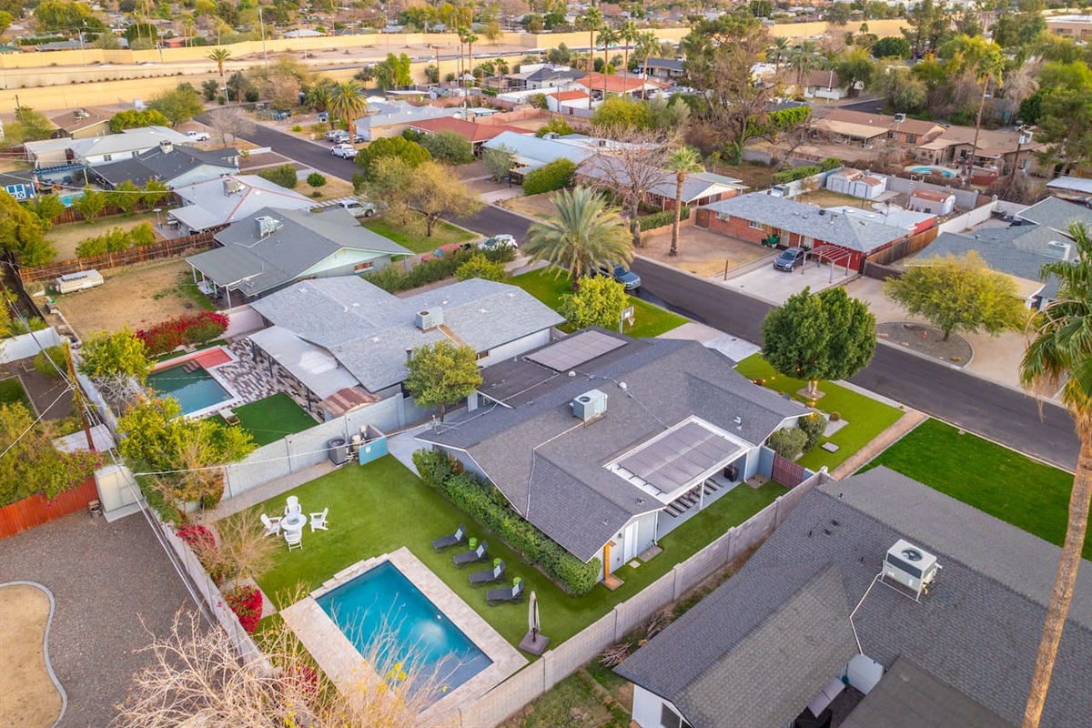 Aerial view showcasing the full layout of the area, offering a unique perspective of the pool, garden, and surrounding landscape.