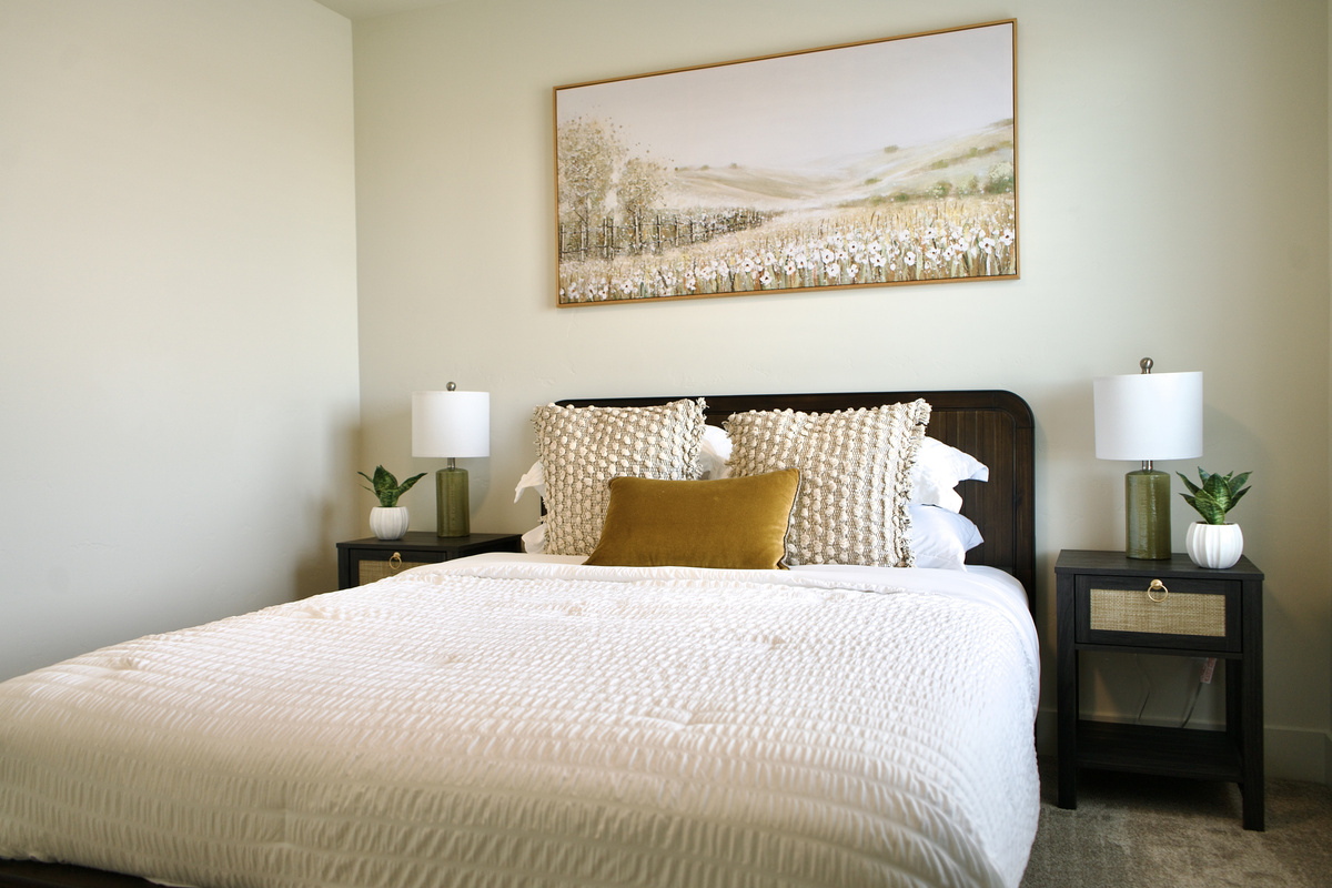 Third bedroom upstairs, furnished with a queen bed and bedside tables on both sides. This room features spacious closets and is thoughtfully designed with elegant, stylish finishes.