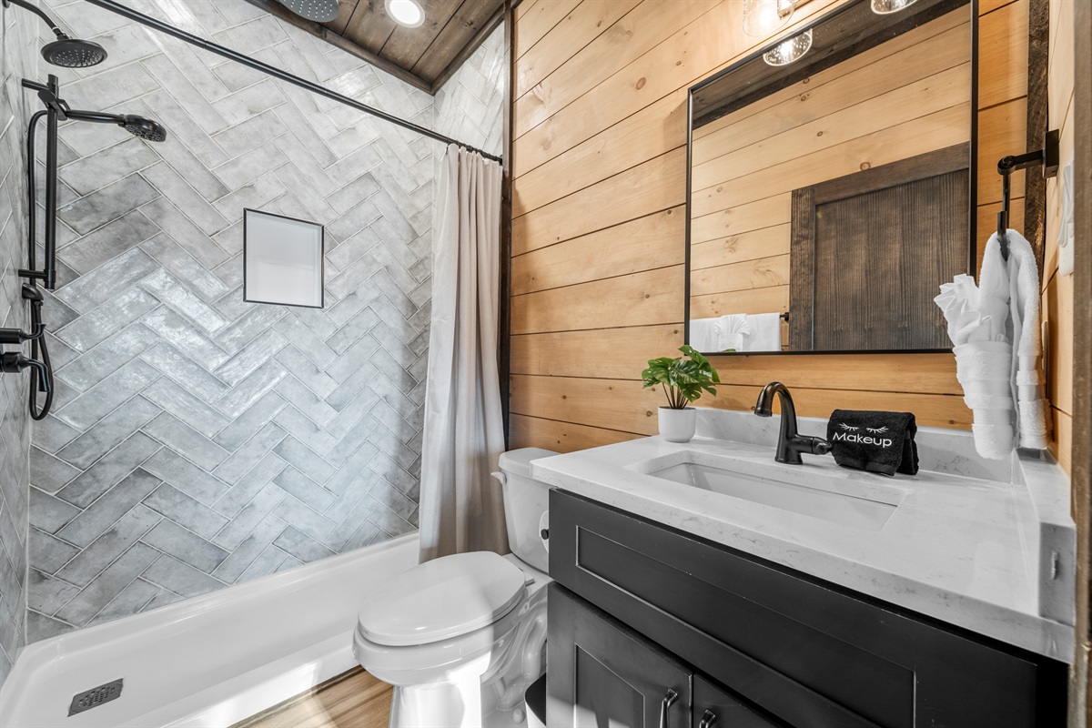5 full bathrooms + 2 half baths with modern finishes and walk-in showers.