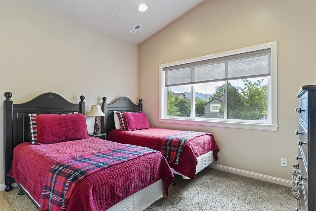 Cozy bedroom with two twin beds—perfect for kids or friends to relax and recharge.