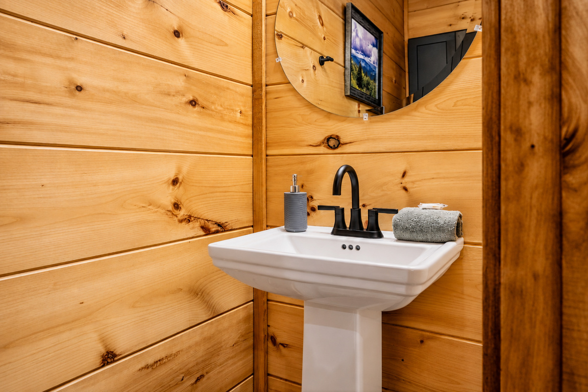 A pedestal sink and round mirror for quick freshen-ups without leaving the fun.
