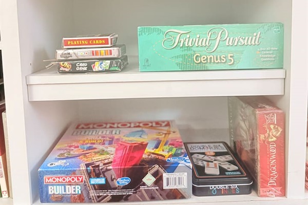A full shelf of classic board games and activities — perfect for family nights or rainy day fun.