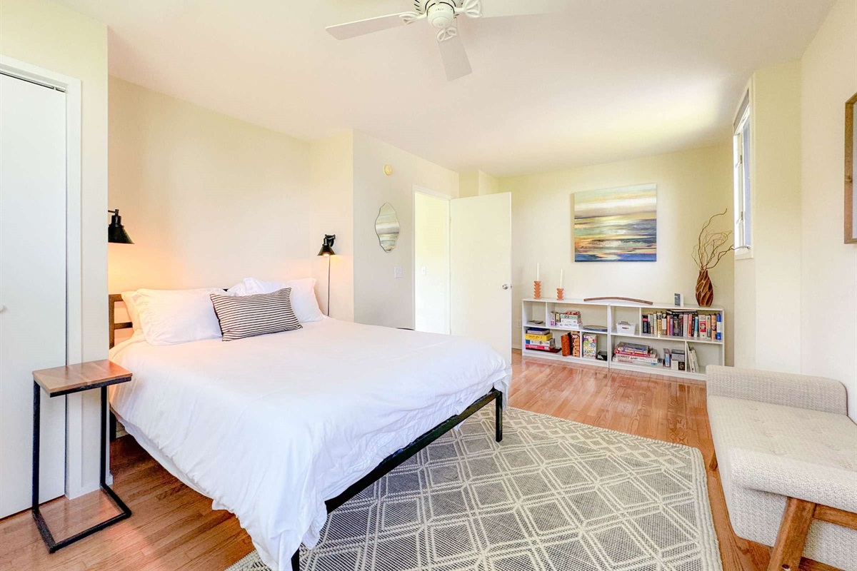 large upstairs bedroom with a queen bed