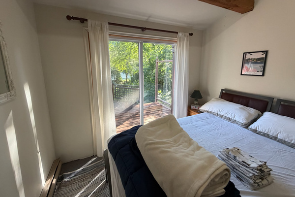 Bedroom C with sliding door out to seating on adjacent deck