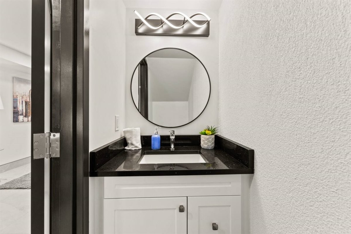 1st floor half bathroom offers modern sophistication along with convenience.