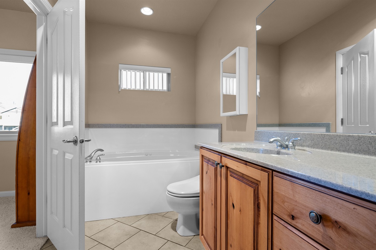 Spa-inspired primary bathroom with soaking tub, double vanity, and elegant finishes.