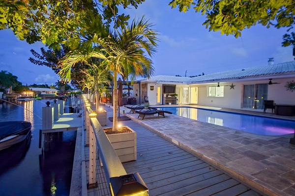 Luxury canal-side lounge with paddleboards and kayaks