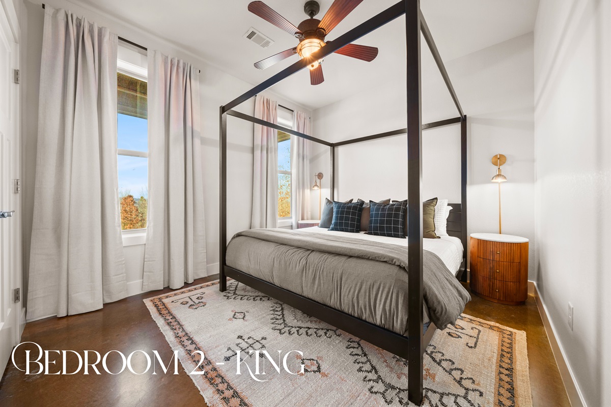 Bedroom two features a beautiful king bed and warm natural light, creating a cozy and restful space to recharge.