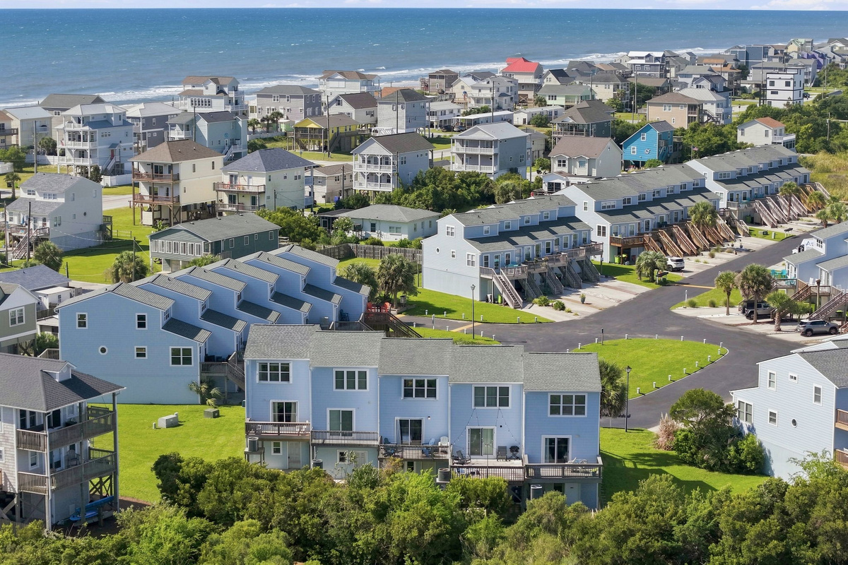 A stunning birds-eye view showcasing the winding coastal waterways, sandy beaches, and neighborhood layout.