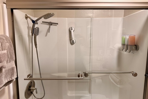 Hall bathroom tub shower combo. Soap dispenser has shampoo, conditioner, and body wash.