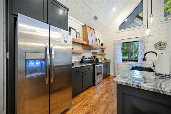 Another angle of your stylish kitchen—showcasing sleek appliances, rustic open shelving, and your stunning marble countertop!