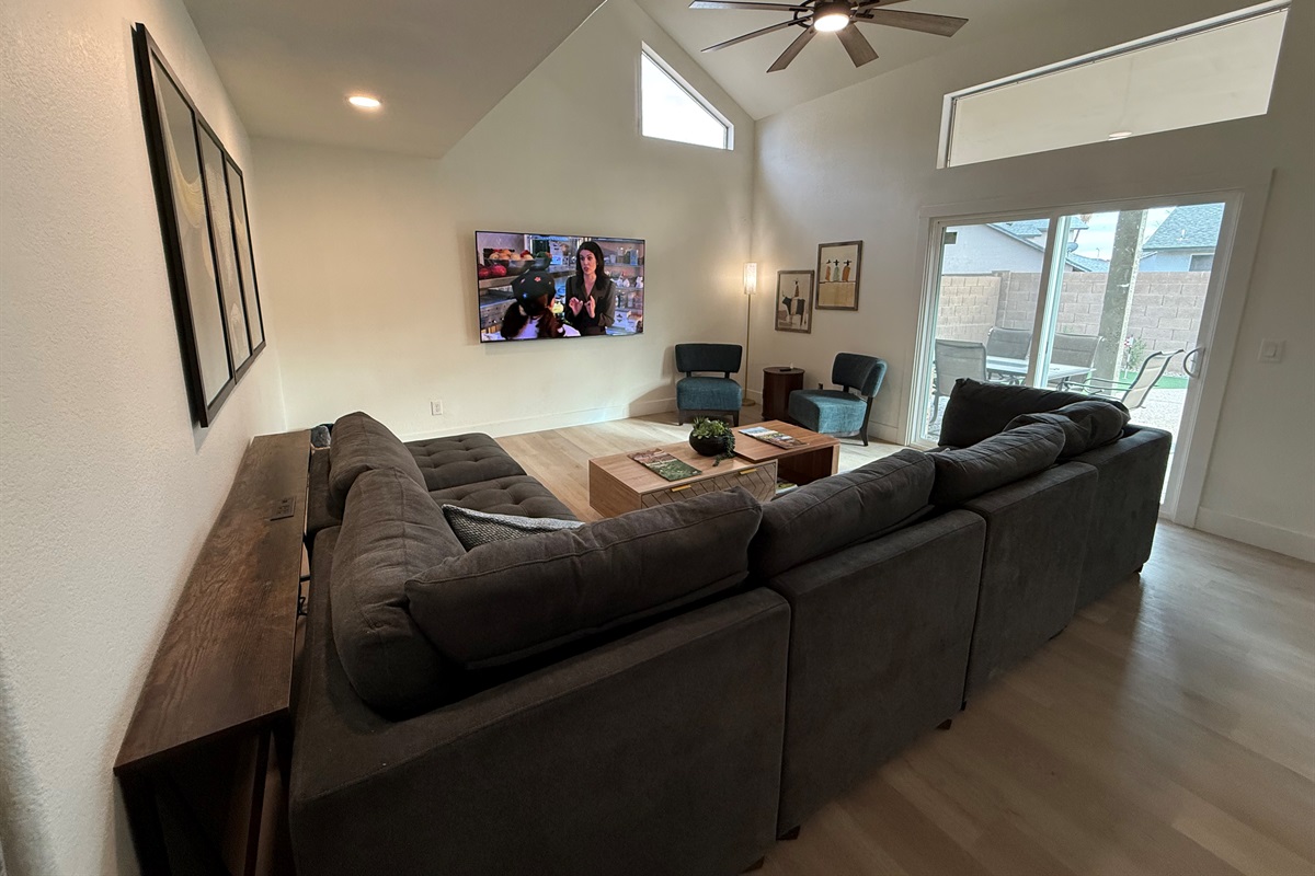 Large living room with door to patio & backyard.