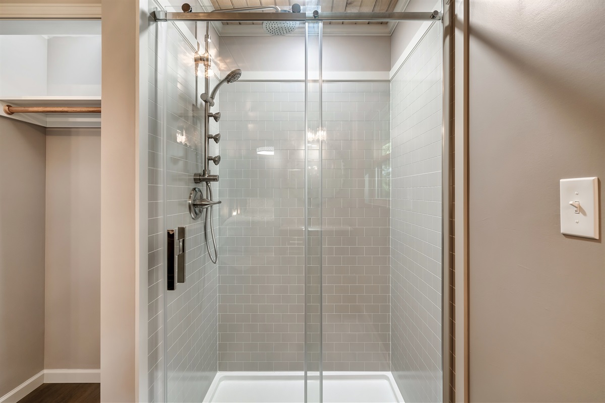 Start your day feeling refreshed! Enjoy the full-body rain shower system and clean, modern subway tile in this beautiful bath.