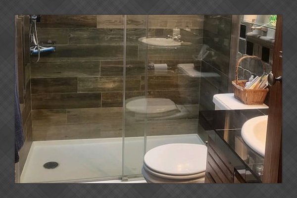 Waterfall shower in guest bathroom next to King guest room and bunk bed room