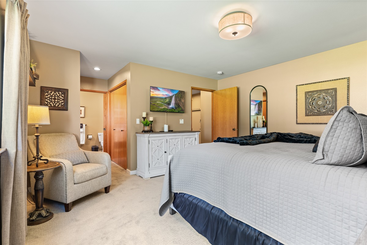Primary Bedroom with smart TV and reading chair