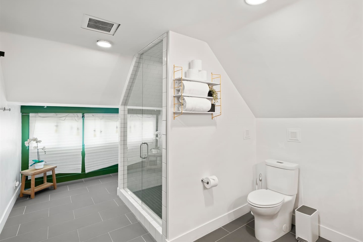 Indulge in a spa-like experience — our oversized bathroom with dual shower heads blends modern luxury with classic charm.