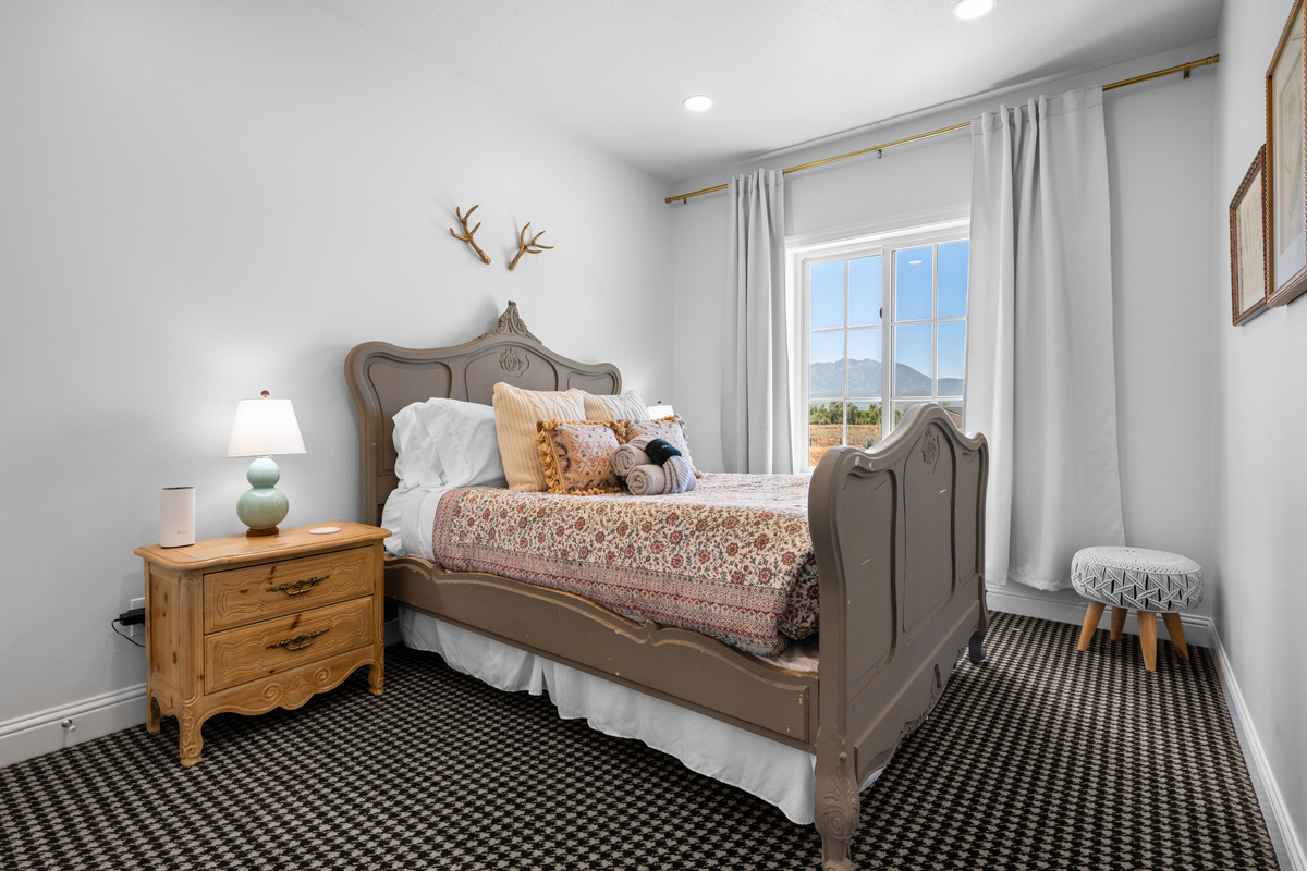 Plush pillows, fresh towels, delicate patterns, and warm bedside lighting add a carefully curated finishing touch to the guest room.