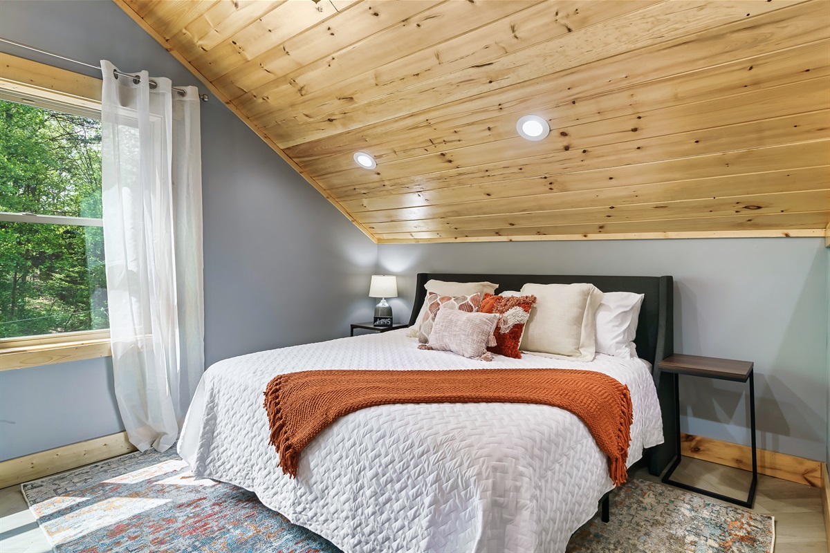 At the top of the stairs, you'll find an incredibly comfortable king bed for your rest and relaxation. 