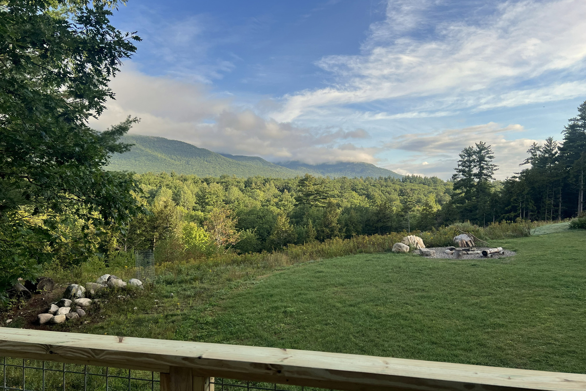 Take in the sweeping mountain views from the deck, overlooking the spacious lawn and inviting outdoor firepit.
