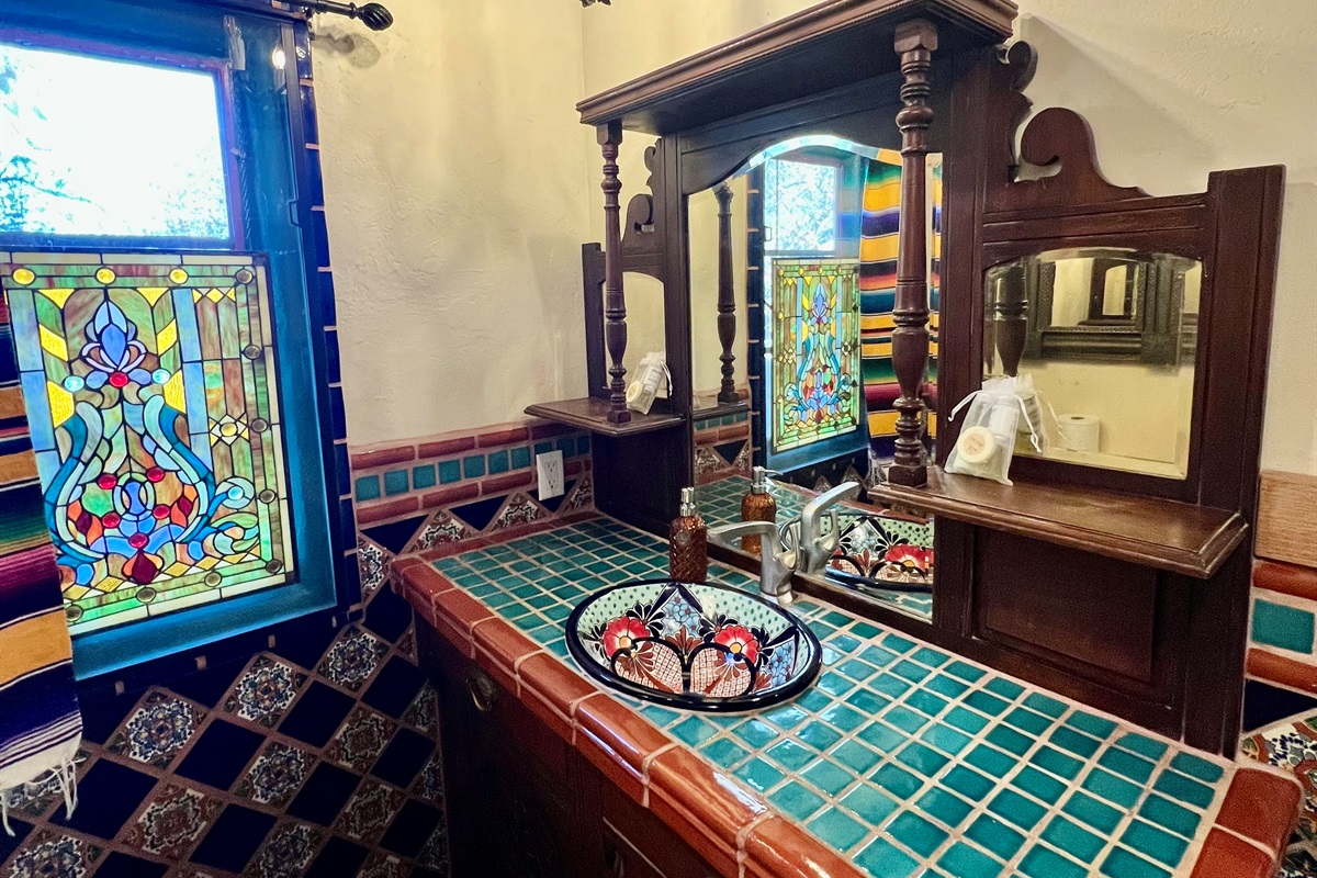 Experience the beauty of authentic tilework in this bathroom, showcasing vibrant colors and traditional patterns.