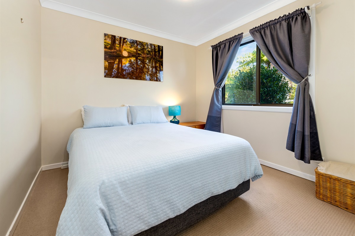 A queen bedroom downstairs gives Bertie’s 3 Beaches extra flexibility, with sleeping spaces spread across both levels of the home.