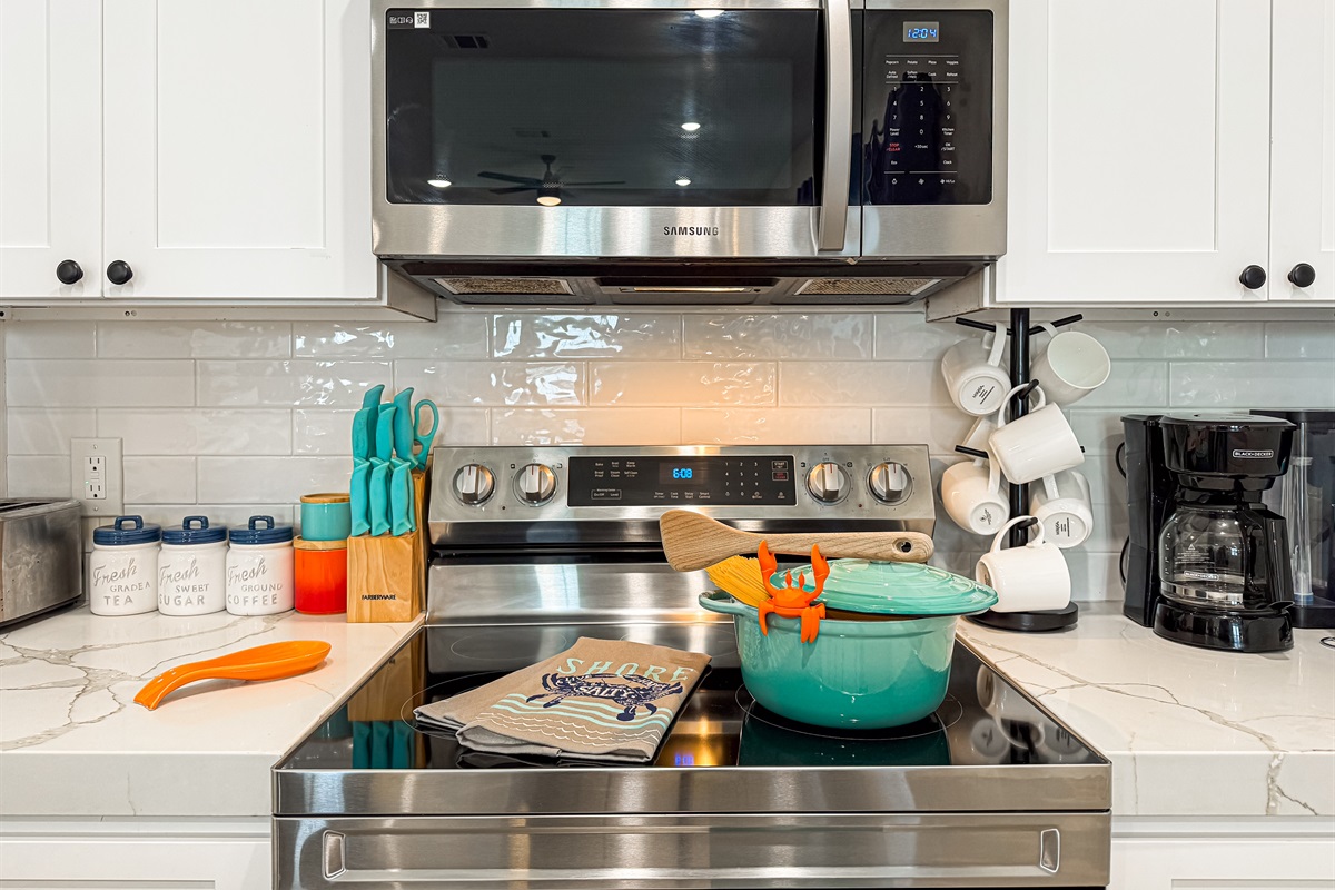 The fully stocked kitchen has stainless steel appliances.