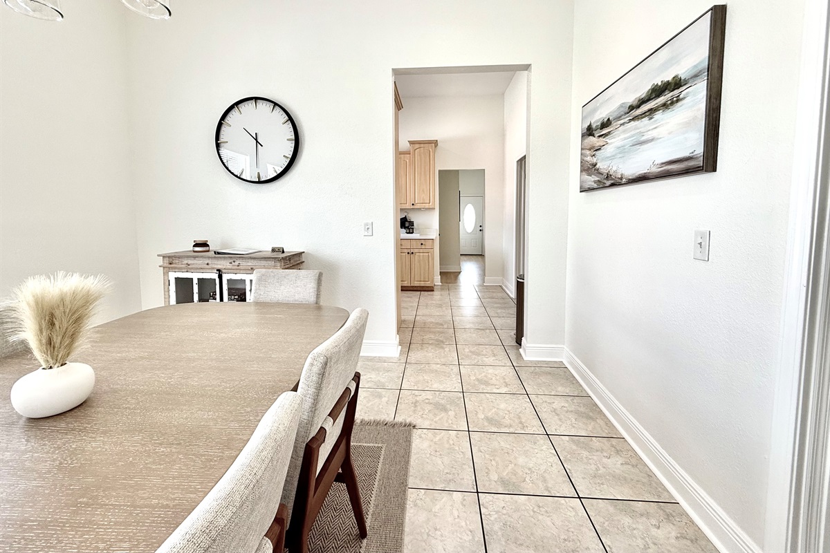 The large, modern dining table with stylish mid-century chairs invites gatherings and shared meals.