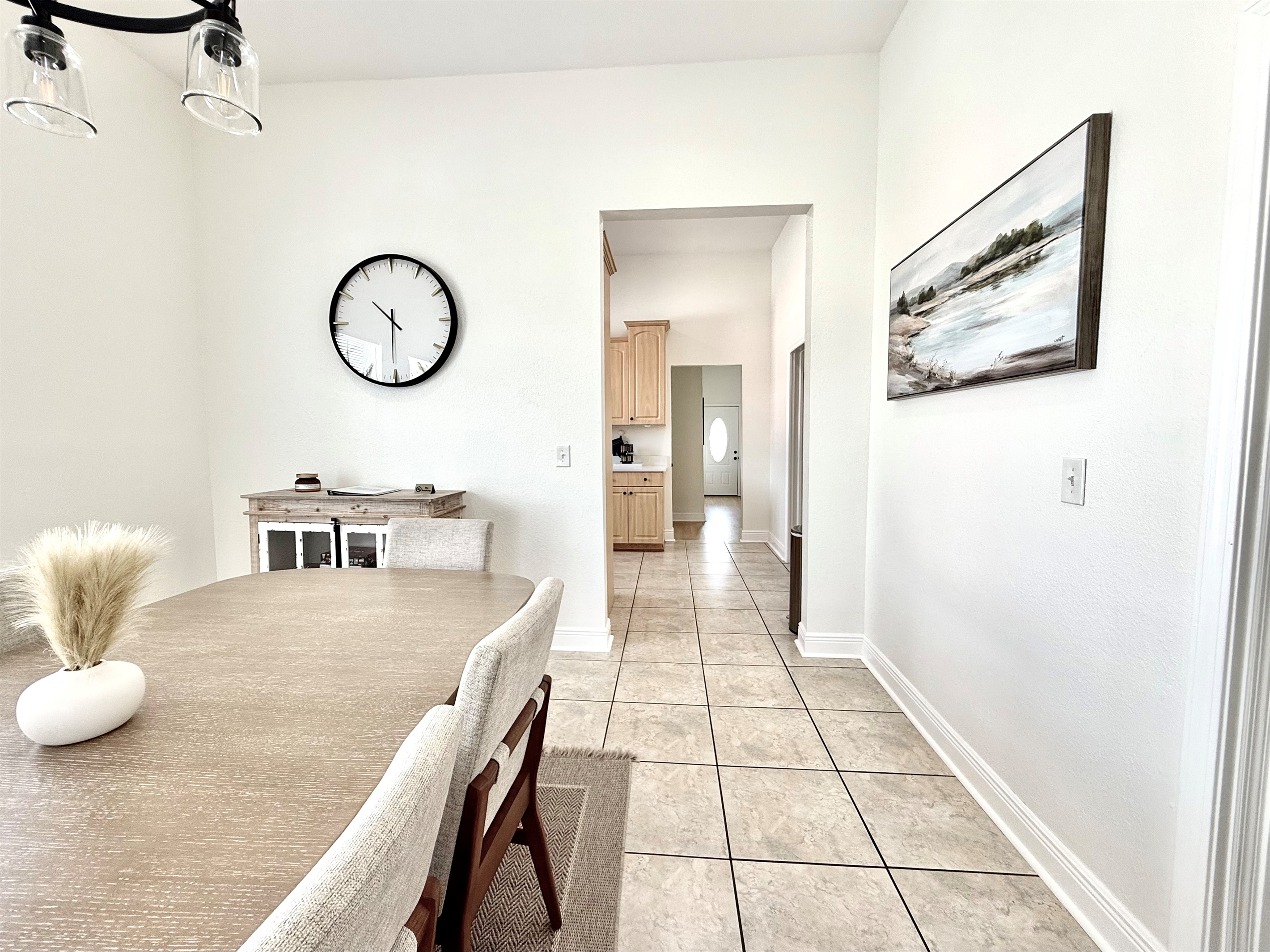 The large, modern dining table with stylish mid-century chairs invites gatherings and shared meals.