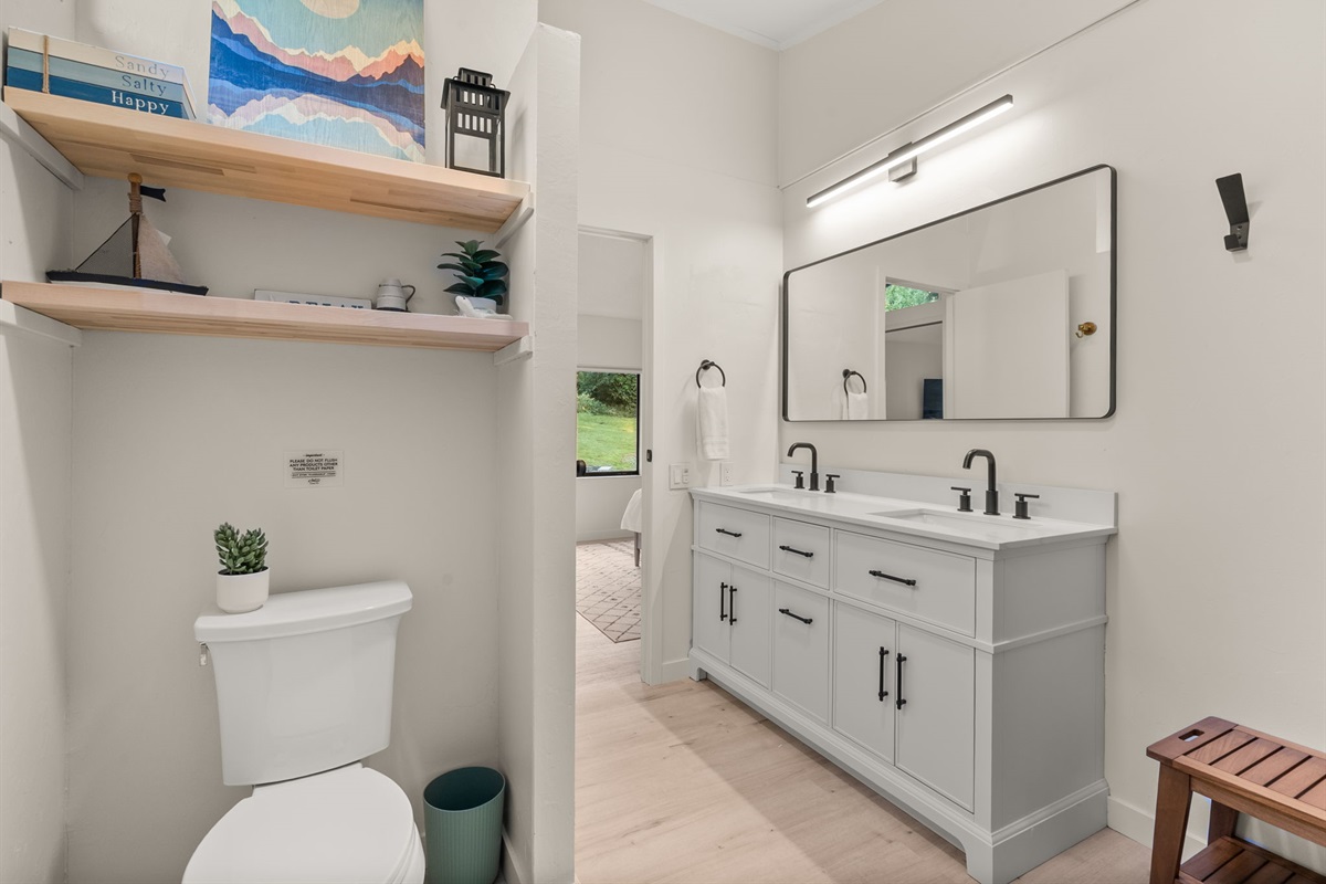 Elegant ensuite featuring stone countertops, double vanities, and refined finishes throughout