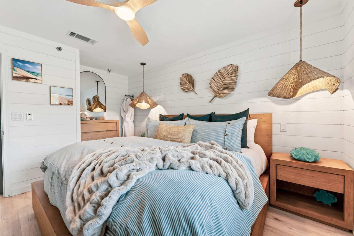 Private king bedroom with coastal decor, rattan pendant lighting and blackout curtains at El Secreto Azul.
