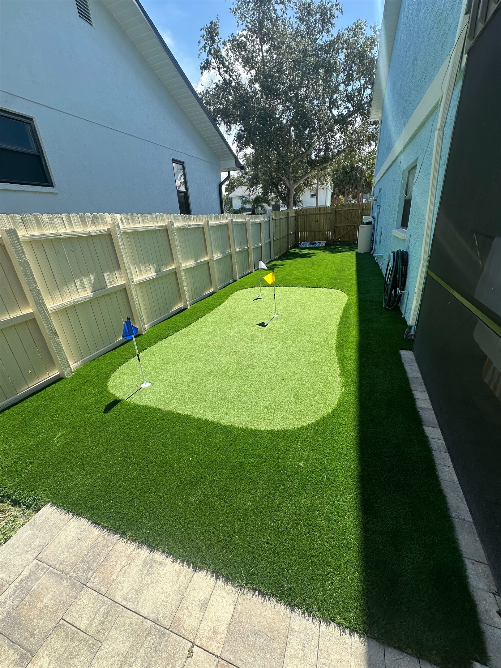 Step outside and discover your own private play zone! This fenced-in backyard features a vibrant cornhole set and a professionally installed putting green—perfect for friendly competition, family fun, or a relaxing solo round of practice.