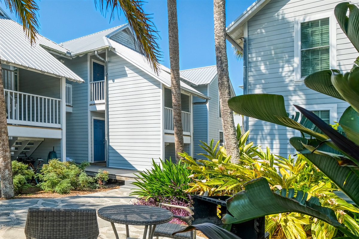 Shared patio area with grill, picnic table and bistro table and chairs