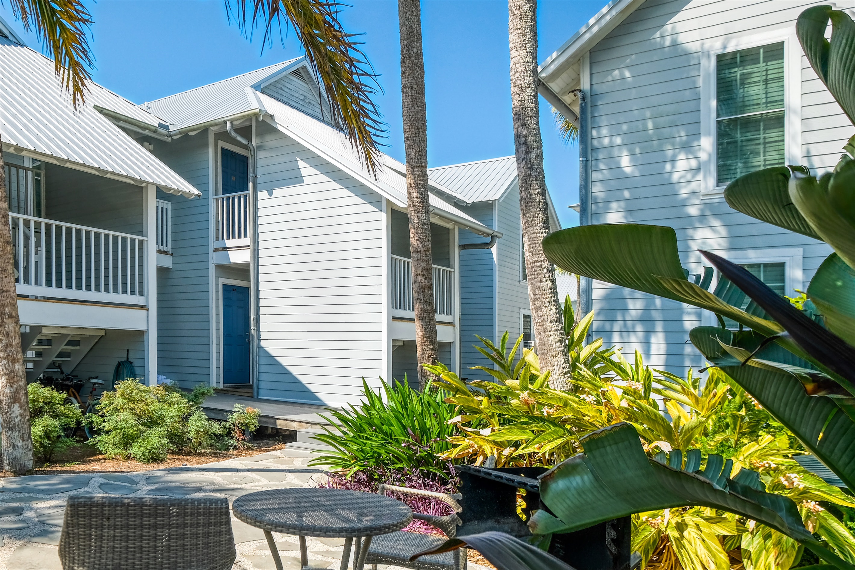 Shared patio area with grill, picnic table and bistro table and chairs