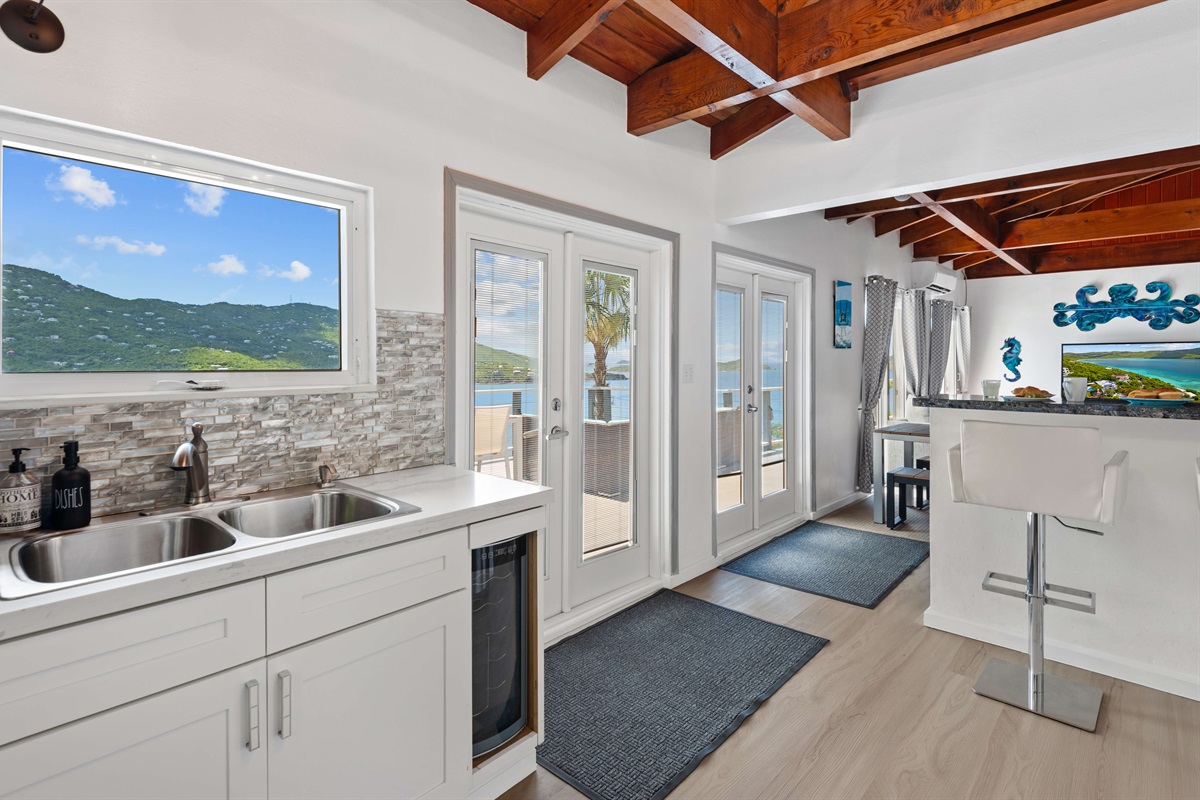 When you enter off of the wrap around balcony, you step into the kitchen and living room space.