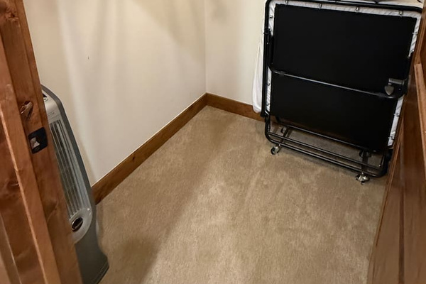 Roll away bed is stored in the attached walk in closet but will be set up in the bedroom for reservations with 10 guests. 