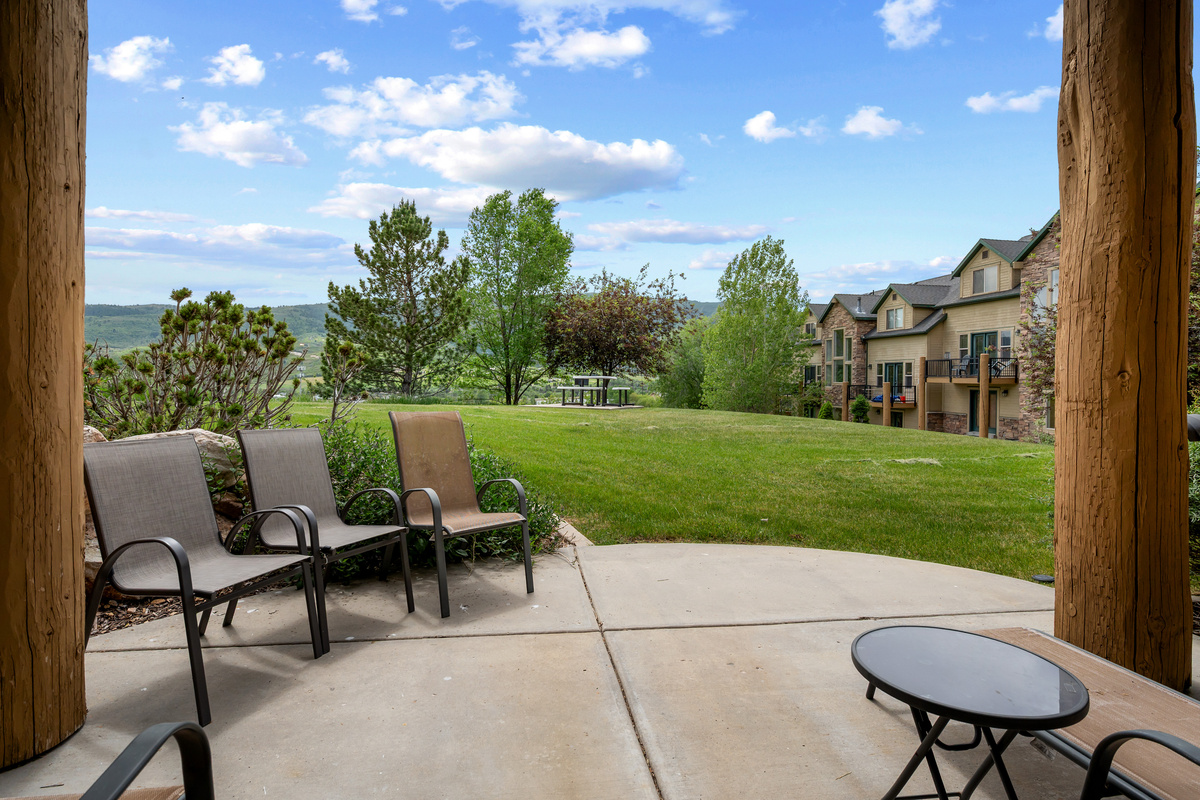 Step outside to enjoy the peaceful patio area with open green space and beautiful mountain surroundings.