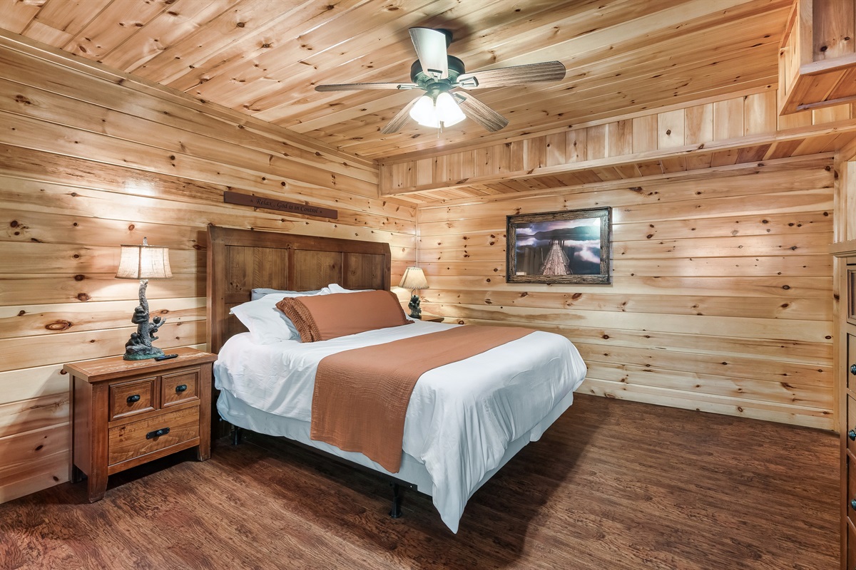 Drift off in a rustic wood paneled bedroom where cozy textures and cabin charm make sleep come easy