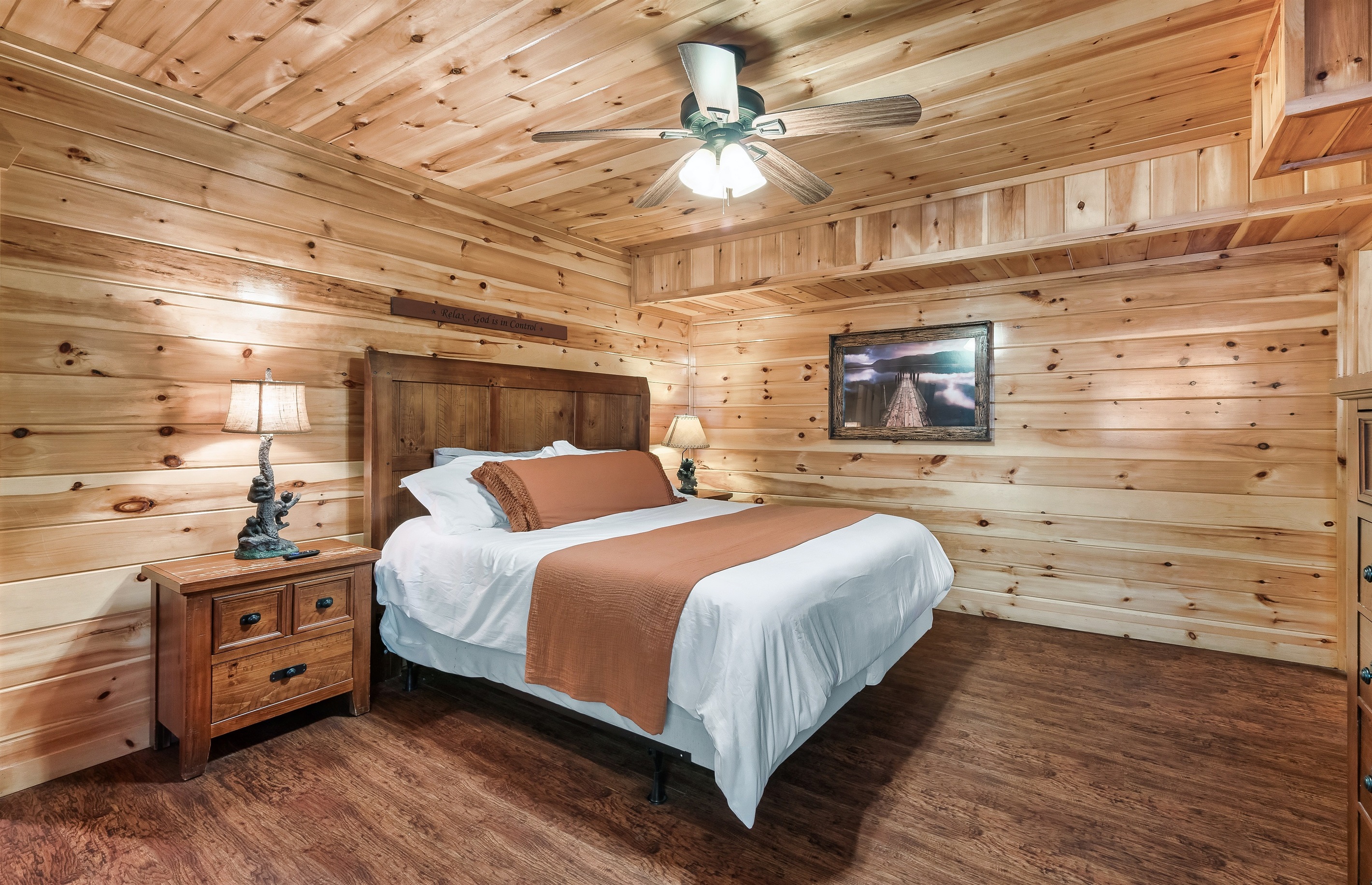 Drift off in a rustic wood paneled bedroom where cozy textures and cabin charm make sleep come easy