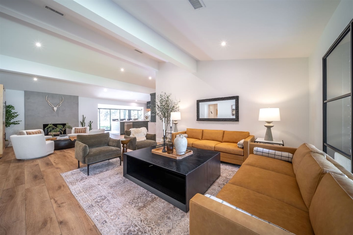Bright living room view emphasizing natural light, open floor plan, and comfortable seating for gathering or lounging.