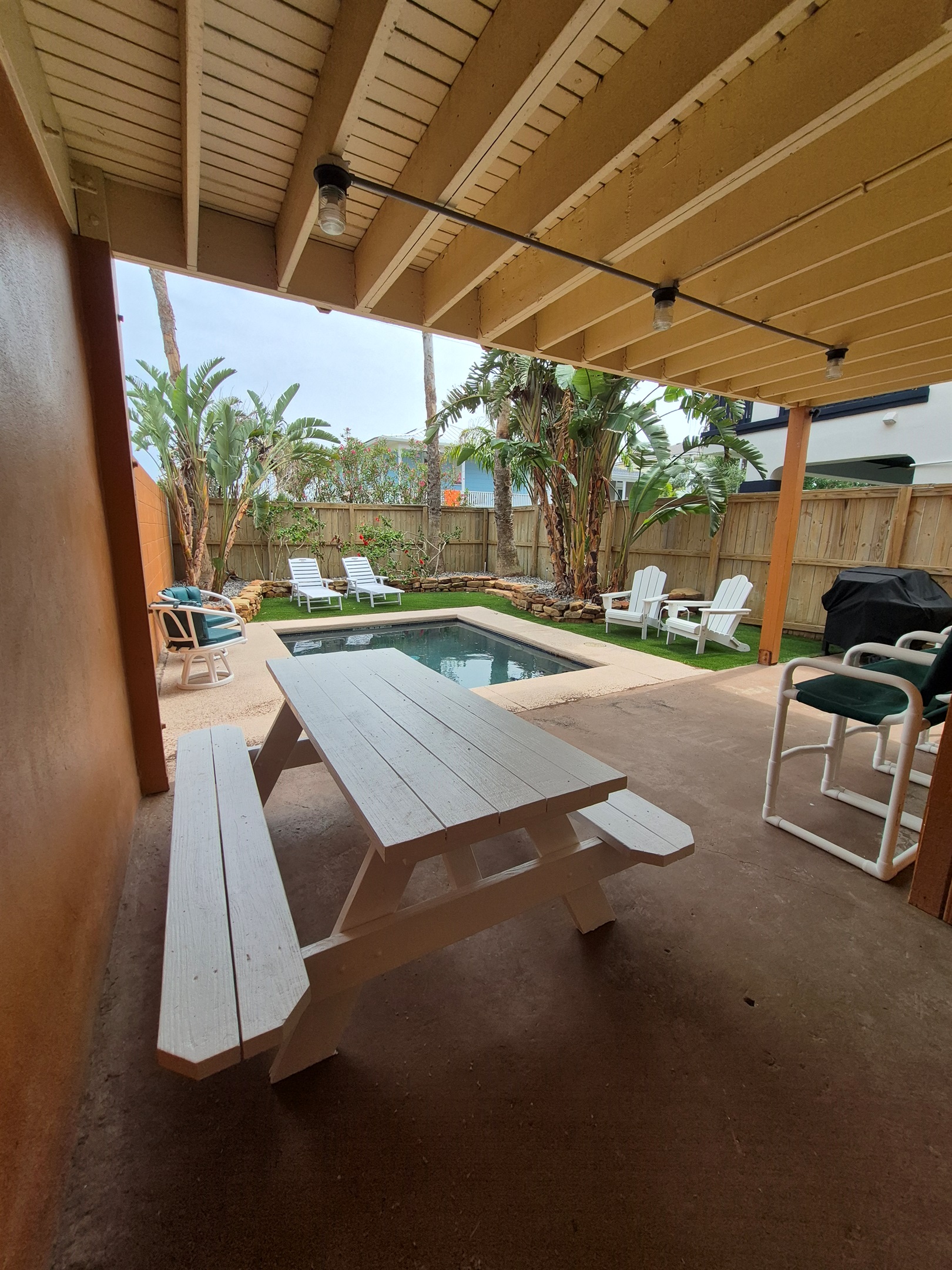 Unwind in our tropical backyard featuring thoughtfully designed landscaping, sparkling dipping pool, and lounge seating.
